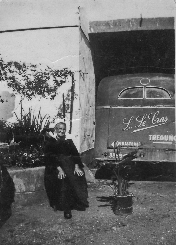 Marie Drouglazet (Le Maout ) assise devant le car de Louis le Cras. Rue de Saint-Philibert